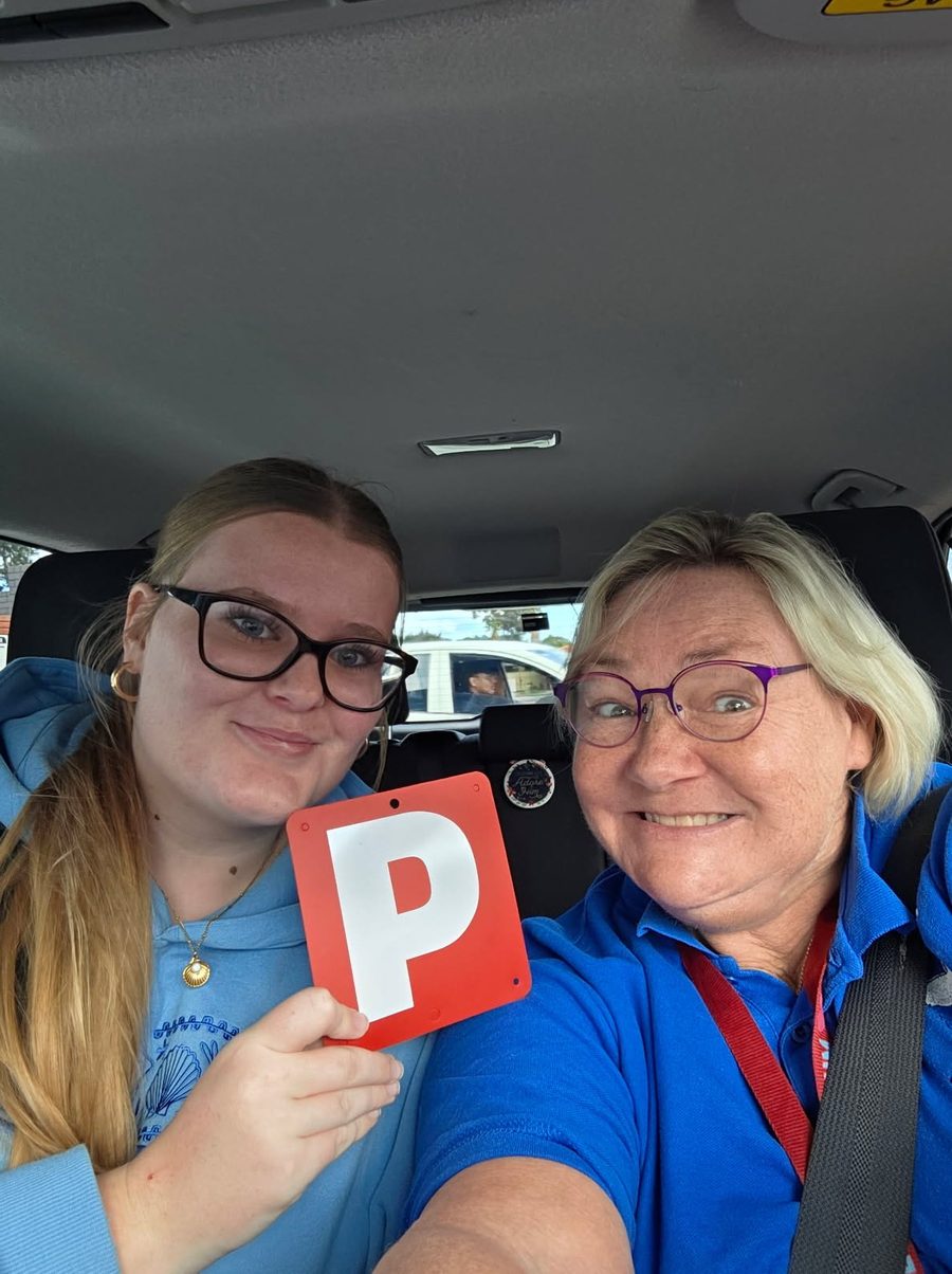 Lisa Archer in the car beside a smiling student holding her P plate